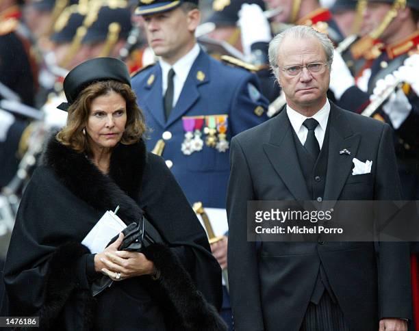 King Carl XVI Gustaf and Queen Silvia of Sweden bow to the Dutch Royal standard after the funeral ceremony of Prince Claus of the Netherlands at the...