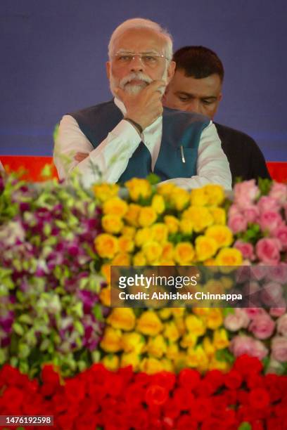 India's Prime Minister Narendra Modi listens to a speaker during a political event organised by the Bharatiya Janata Party at the GMIT College...