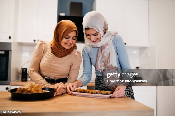 two happy muslim women preparing food for the ramadan feast - ramadan giving imagens e fotografias de stock