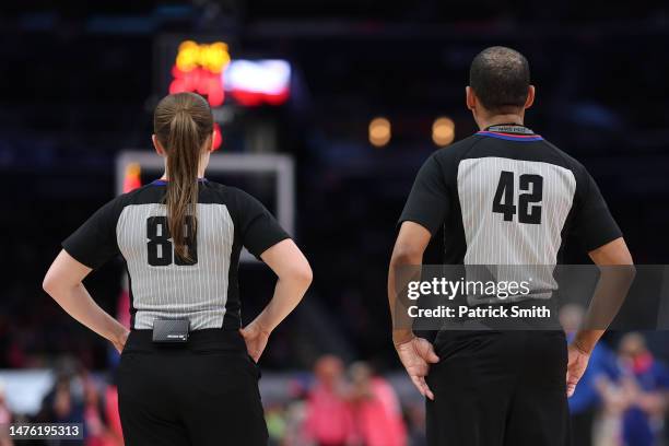 Referee Dannica Mosher and referee Eric Lewis Iook on during the first half at Capital One Arena on March 24, 2023 in Washington, DC. NOTE TO USER:...