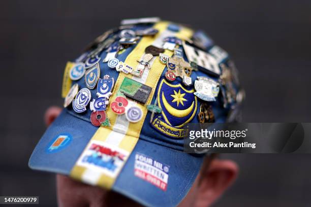 Detailed view of pin badges on a supporters cap prior to the Sky Bet League One between Portsmouth and Port Vale at Fratton Park on March 25, 2023 in...