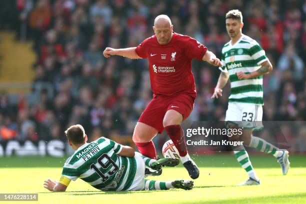 Charlie Adam of Liverpool is tackled by Stiliyan Petrov of Celtic during the Legends match between Liverpool and Celtic at Anfield on March 25, 2023...