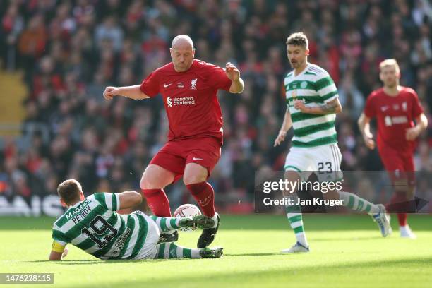 Charlie Adam of Liverpool is tackled by Stiliyan Petrov of Celtic during the Legends match between Liverpool and Celtic at Anfield on March 25, 2023...