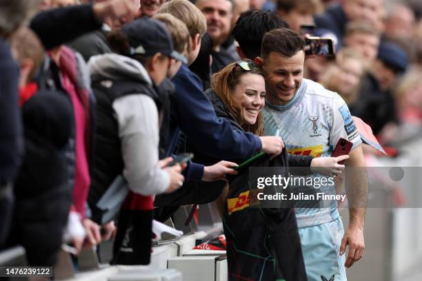 Danny Care of Harlequins poses for a photo with a fan following the Gallagher Premiership Rugby match between Saracens and Harlequins at Tottenham...