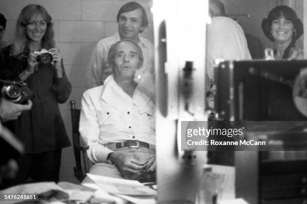 Award-winning actor Henry Fonda prepares to be filmed for a Boy Scouts of America television commercial backstage in a makeup room surrounded by...