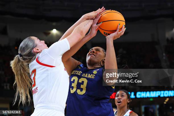 Lauren Ebo of the Notre Dame Fighting Irish shoots the ball against Faith Masonius of the Maryland Terrapins during the second half in the Sweet 16...