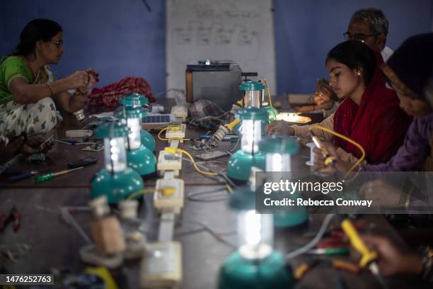 Indian villagers assemble solar lamps in a class held as part of the Barefoot Solar Project to bring solar powered lighting to rural areas on March...