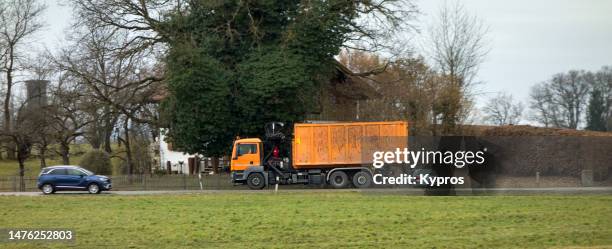 industrial waste removal truck or tipper - garbage truck driving stock pictures, royalty-free photos & images