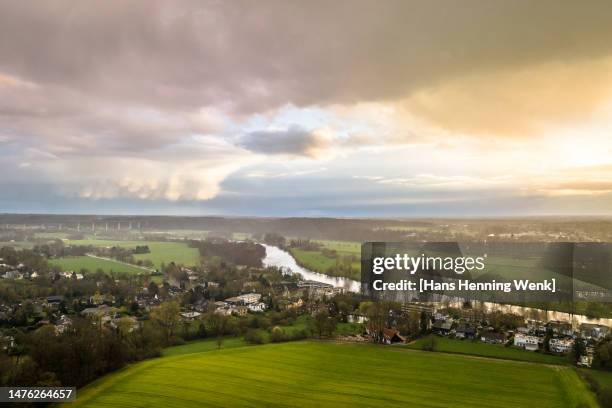 dramatic sunset and cloudscape over rural area and river - ruhr stock pictures, royalty-free photos & images