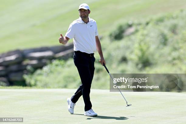 Scottie Scheffler of the United States reacts after making birdie on the ninth green to win the hole against Jason Day of Australia during day four...