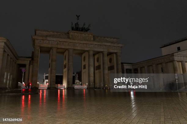 The Brandenburg Gate stands in darkness during Earth Hour 2023 on March 25, 2023 in Berlin, Germany. Earth Hour is an annual event organized by the...