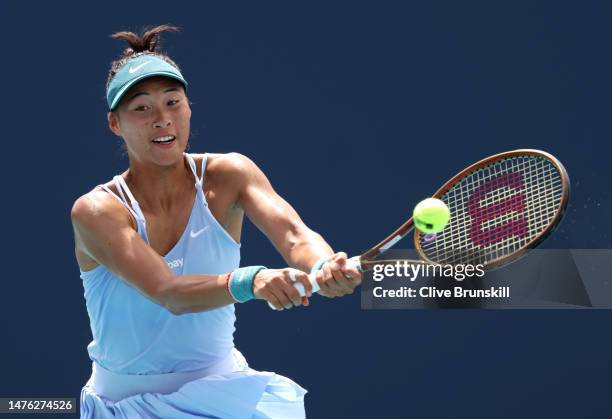 Qinwen Zheng of China plays a backhand against Liudmila Samsonova in their second round match at Hard Rock Stadium on March 25, 2023 in Miami...