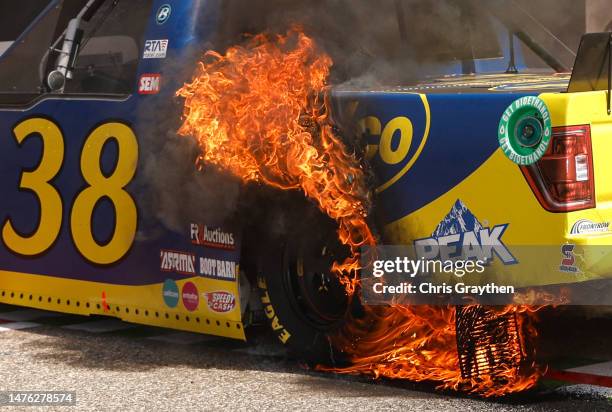 Detail view of the Speedco/Peak Ford, in flames after Zane Smith celebrated with a burnout after winning the NASCAR Craftsman Truck Series XPEL 225...