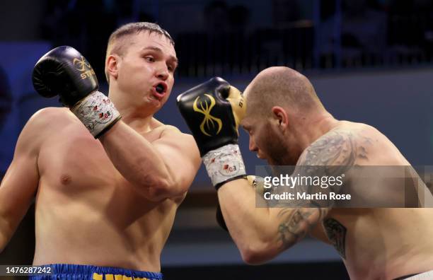 Viktor Jurk of Germany exchanges punches with Lukas Wacker of Czech Republic during their Heavyweight fight at Grand Elysée Hamburg on March 25, 2023...