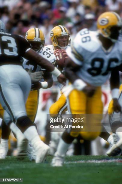 Quarterback Brett Favre of the Green Bay Packers drops back to pass in the Pro Football Hall Of Fame Game between the Green Bay Packers vs the Los...