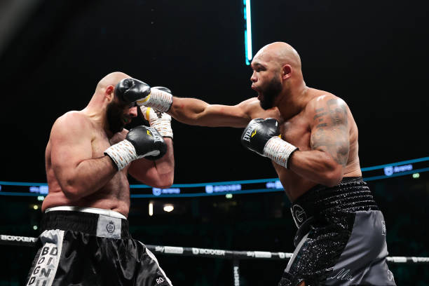 Frazer Clarke punches Bogdan Dinu during their 8x3 Heavyweight fight at AO Arena on March 25, 2023 in Manchester, England.