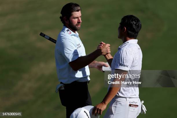 Cameron Young of the United States and Kurt Kitayama of the United States shake hands on the 18th green after Young won their match 1 up during day...