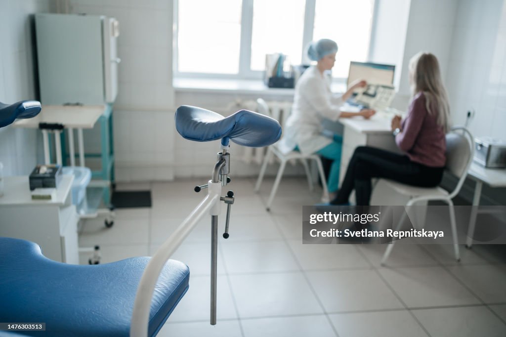 Woman doctor gynecologist consulting a patient at the reception