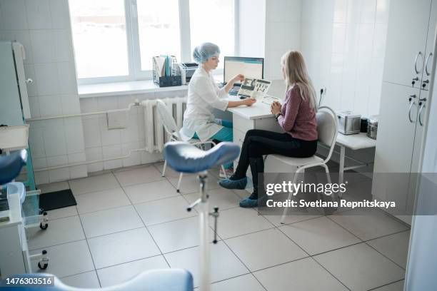 woman doctor gynecologist consulting a patient at the reception - pap smear exam stock pictures, royalty-free photos & images