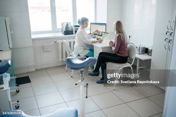 woman doctor gynecologist consulting a patient at the reception - cervical pap smear stock pictures, royalty-free photos & images