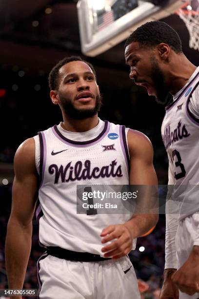 Markquis Nowell and David N'Guessan of the Kansas State Wildcats celebrate a basket against the Florida Atlantic Owls during the first half in the...