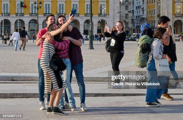 Tourists take selfies in Praça do Comercio at the end of the afternoon on March 25, 2023 in Lisbon, Portugal. Revenue from tourist accommodation...