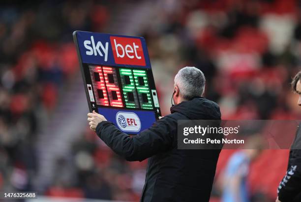 Fourth Official Seb Stockbridge holds up the board at a substitution during the Sky Bet League Two between Doncaster Rovers and Northampton Town at...