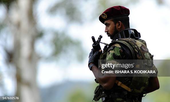 A Sri Lankan special forces commando stands guard during a ceremony ...