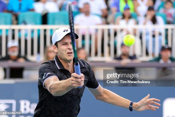 Hubert Hurkacz of Poland returns a serve to Thanasi Kokkinakis of Australia the Miami Open held at Hard Rock Stadium on March 25, 2023 in Miami...