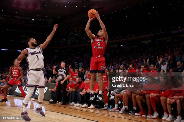 Bryan Greenlee of the Florida Atlantic Owls shoots a three point basket against Markquis Nowell of the Kansas State Wildcats during the second half...