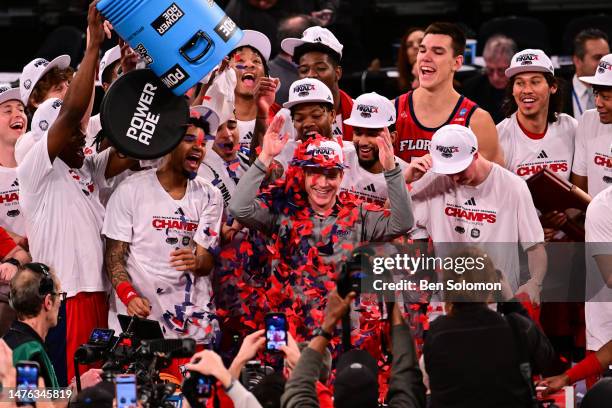 Head coach Dusty May of the Florida Atlantic Owls has confetti poured on his head after defeating the Kansas State Wildcats in the game during the...