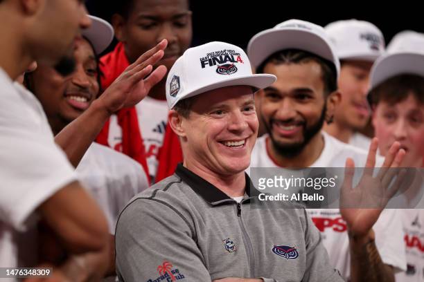 Head coach Dusty May of the Florida Atlantic Owls celebrates with the team after defeating the Kansas State Wildcats in the Elite Eight round game of...