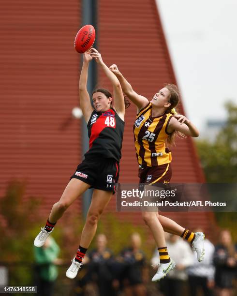 Madison Gray of Essendon and Emily Everist of the Box Hill Hawks contest the ball during the round one VFLW match between the Essendon Bombers and...