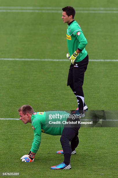 Marc-André ter Stegen and Janis Jonathan Blaswich stretch during the training session of Borussia Moenchengladbach at the club's training ground on...