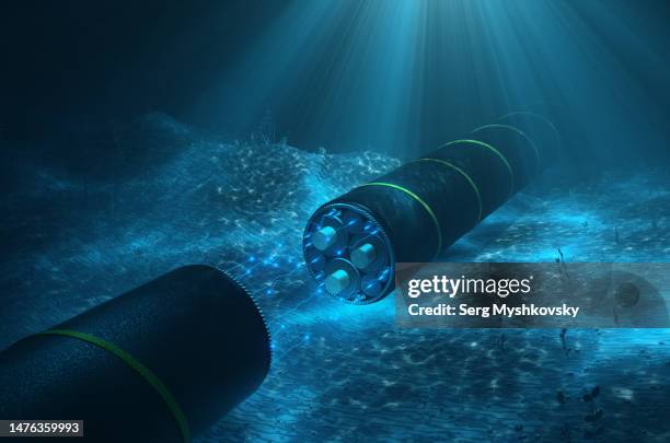 close-up of a cutaway undersea cable with glowing fiberglass on the seabed. cable for transmission of electricity and internet under the water of the ocean. - undersea stock pictures, royalty-free photos & images