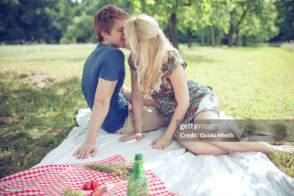 Young couple kissing under tree