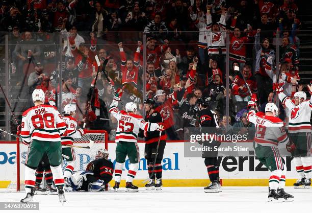 Kevin Bahl, Jack Hughes, Jesper Bratt, Ondrej Palat and Dougie Hamilton of the New Jersey Devils celebrate a goal by Hamilton as Dylan Ferguson of...