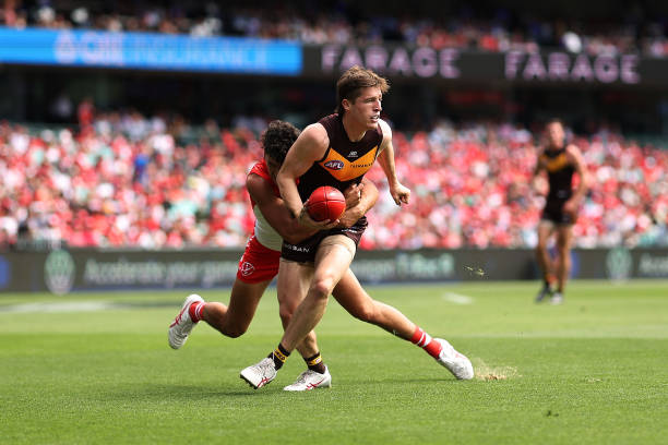 Josh Ward of the Hawks is tackled by Justin McInerney of the Swans during the round two AFL match between Sydney Swans and Hawthorn Hawks at Sydney...