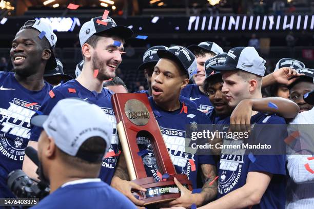 Jordan Hawkins of the Connecticut Huskies celebrates with teammates and the trophy after defeating the Gonzaga Bulldogs 82-54 in the Elite Eight...