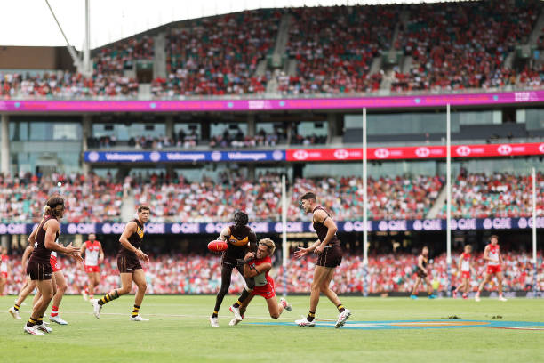 Changkuoth Jiath of the Hawks is tackled by James Rowbottom of the Swans during the round two AFL match between Sydney Swans and Hawthorn Hawks at...