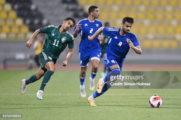 Yousef Alhaqqan of Kuwait on the ball as Ahmed Mazen Alghamdi closes down during the friendly match between Saudi Arabia and Kuwait at Suheim bin...