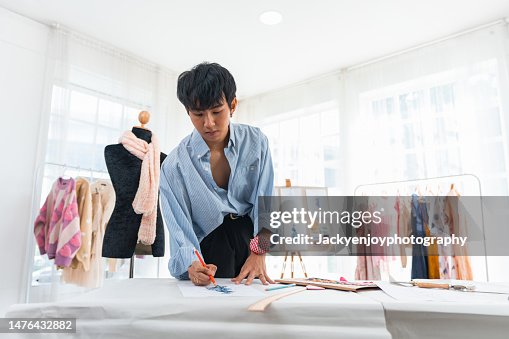 Young fashion designer working at fashion studio Young fashion designer working at fashion studio