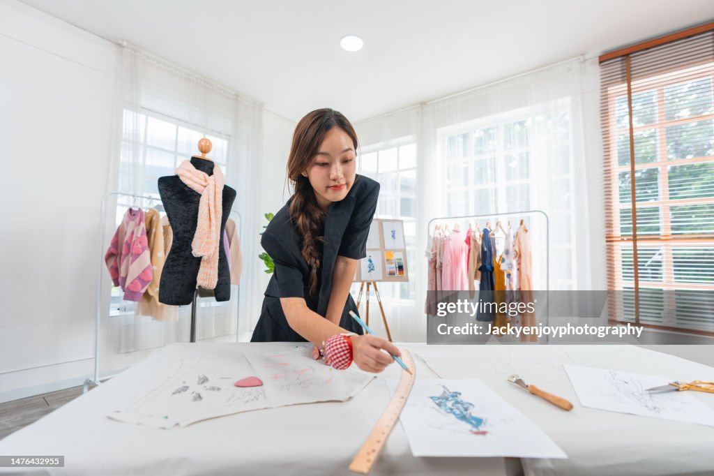 Fashion designer is drawing an artistic fashion sketch