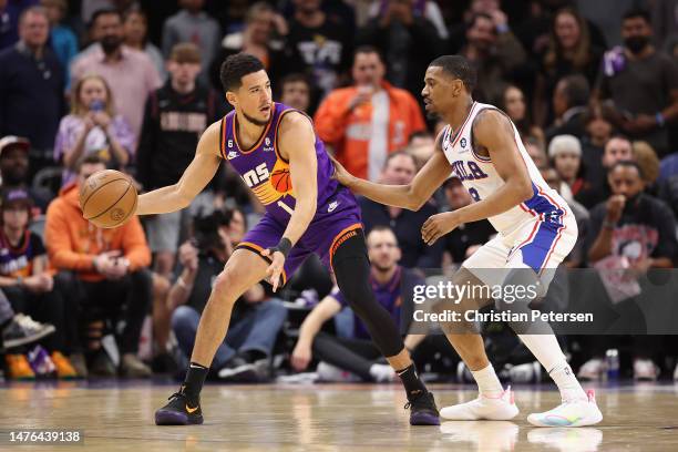 Devin Booker of the Phoenix Suns handles the ball against De'Anthony Melton of the Philadelphia 76ers during the first half of the NBA game at...