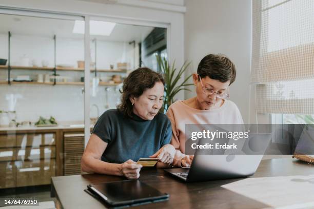 first step for senior friends enjoy shopping online at home - credit history stock pictures, royalty-free photos & images