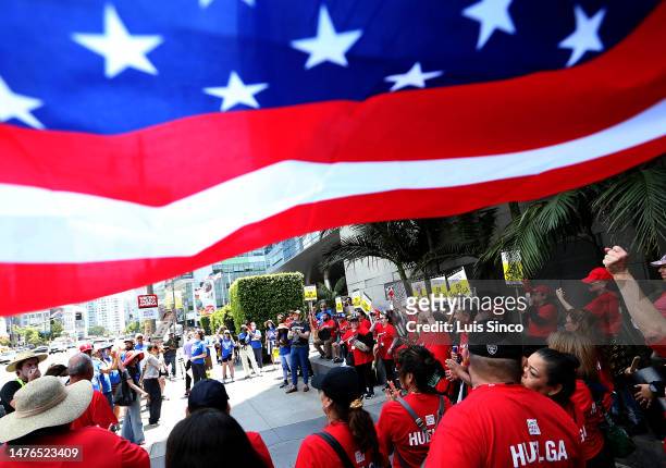 Los Angeles, CA - Striking members of the Unite Here Local 11 hotel workers union rally outside of the JW Marriott Hotel in downtown Los Angeles on...
