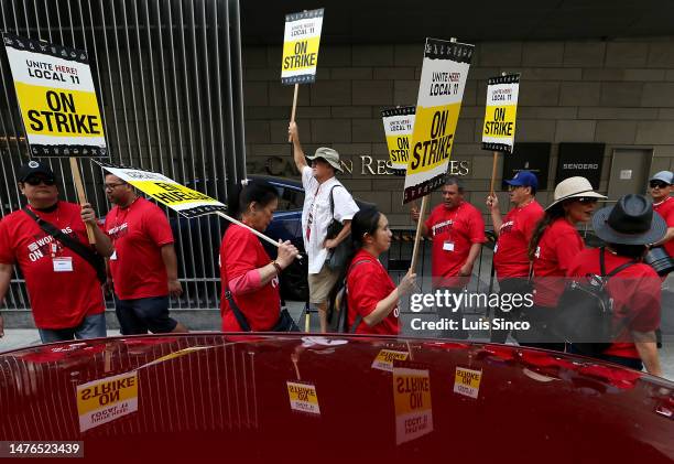 Los Angeles, CA - Striking members of the Unite Here Local 11 hotel workers union picket outside of the JW Marriott Hotel in downtown Los Angeles on...