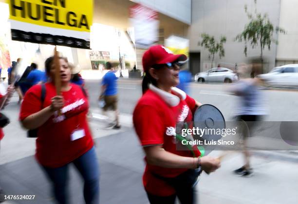 Los Angeles, CA - Striking members of the Unite Here Local 11 hotel workers union rally outside of the JW Marriott Hotel in downtown Los Angeles on...