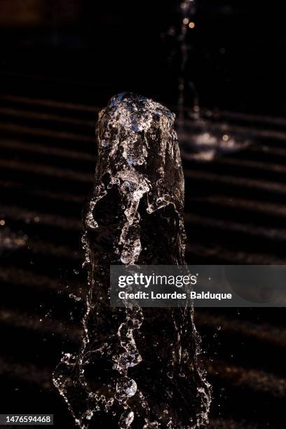 lear water emerging from a fountain and falling outdoors in the daytime - emitting stock pictures, royalty-free photos & images