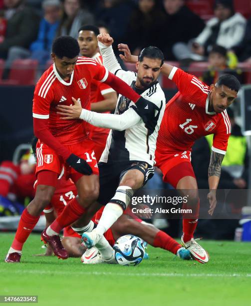 Emre Can of Germany is challenged by Wilder Cartagena and Christofer Gonzalez of Peru during an international friendly match between Germany and Peru...